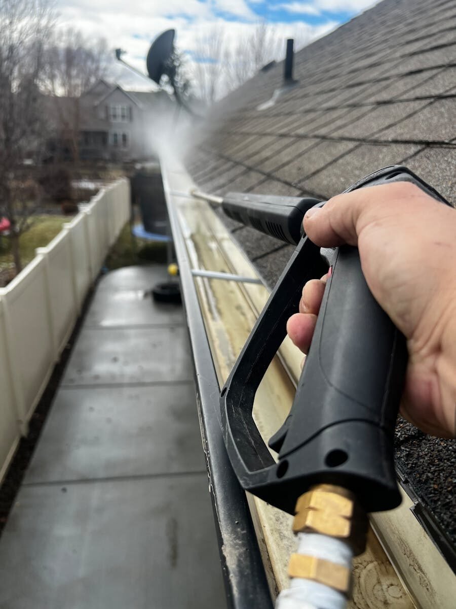 Gutter cleaning with pressure washer.