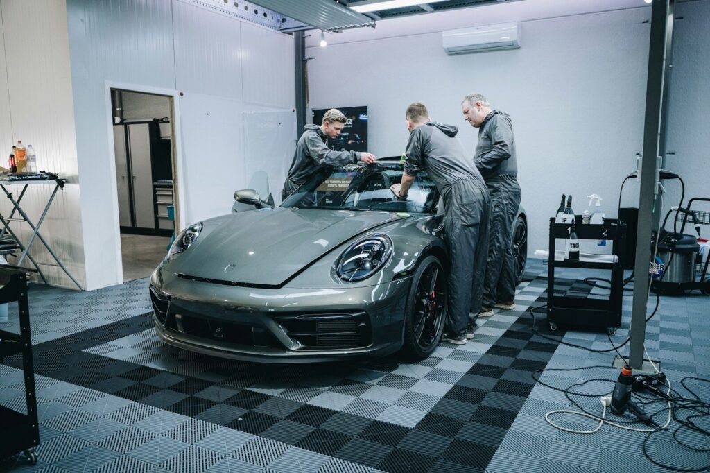 Professional installation of ceramic window tint film on a car in Phoenix