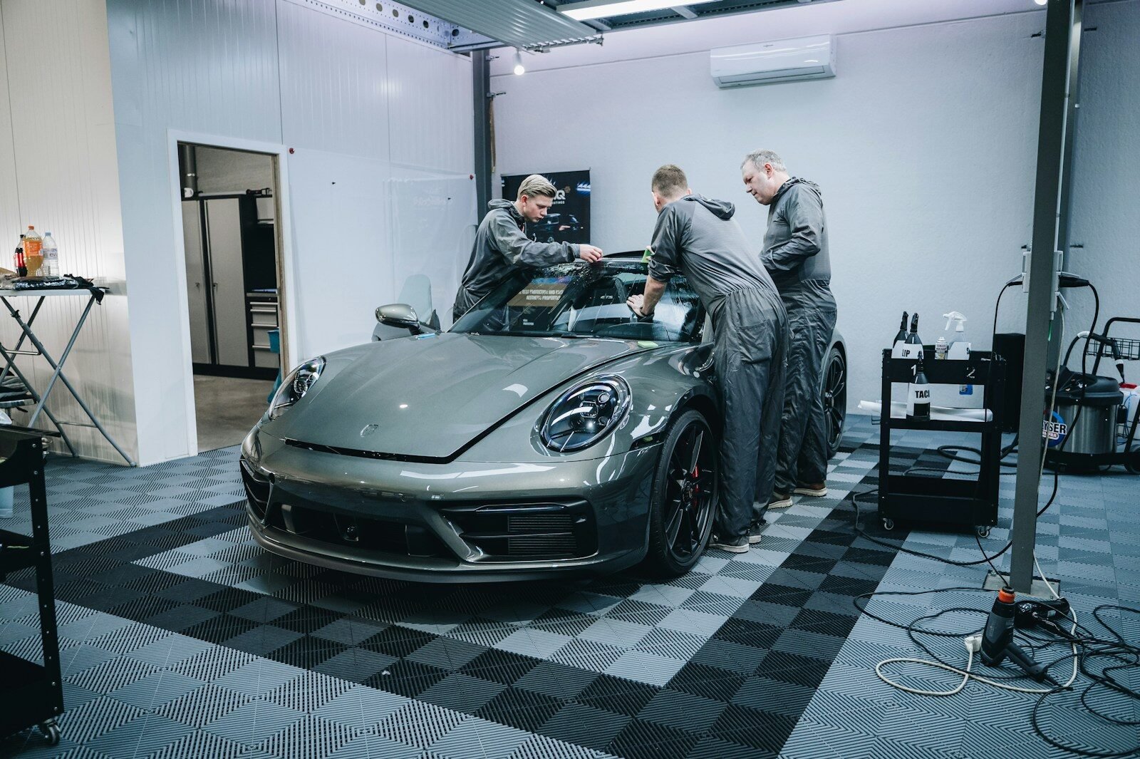 Professional installation of ceramic window tint film on a car in Phoenix